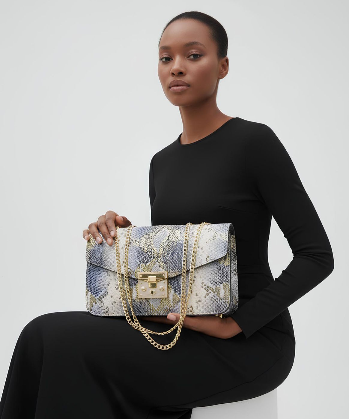 Raisa Bag An image of a Model Carrying A White and Black Exotic Skin Raisa Bag