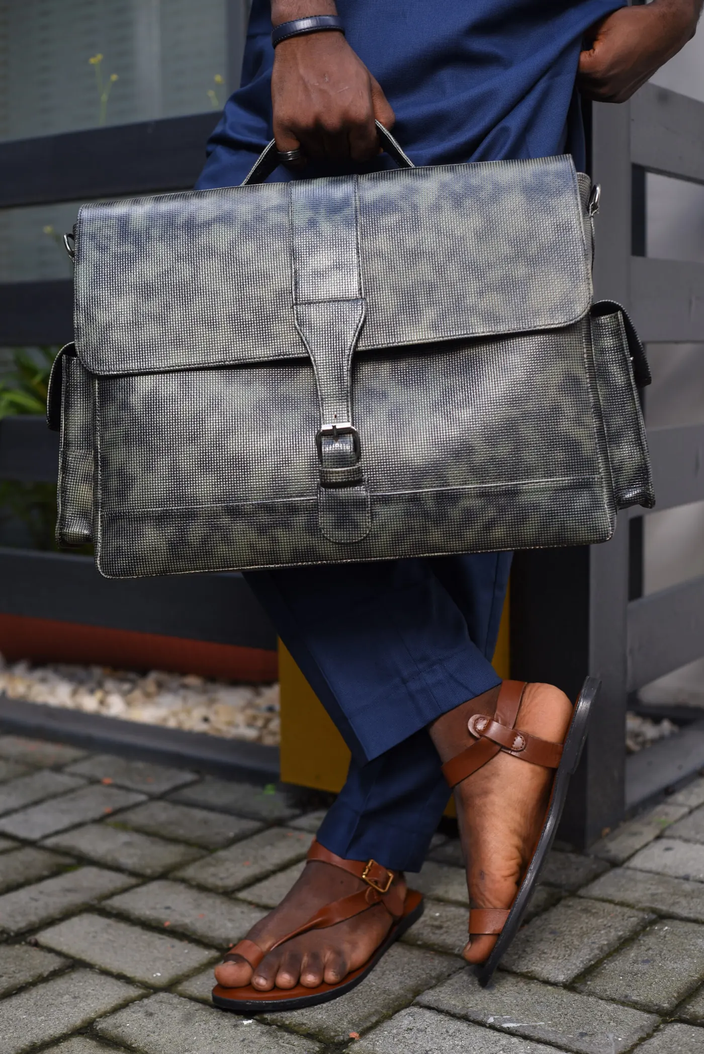 A man carrying a handcrafted african luxury leather bag